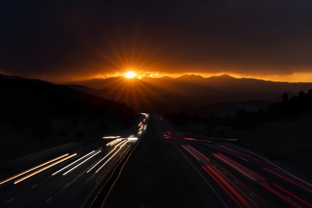 time lapse photography of cars on road during sunset