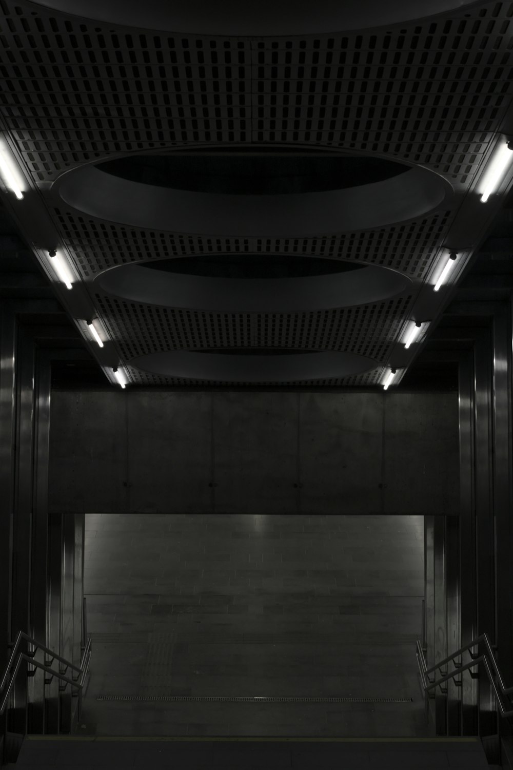 gray concrete building with black metal ceiling