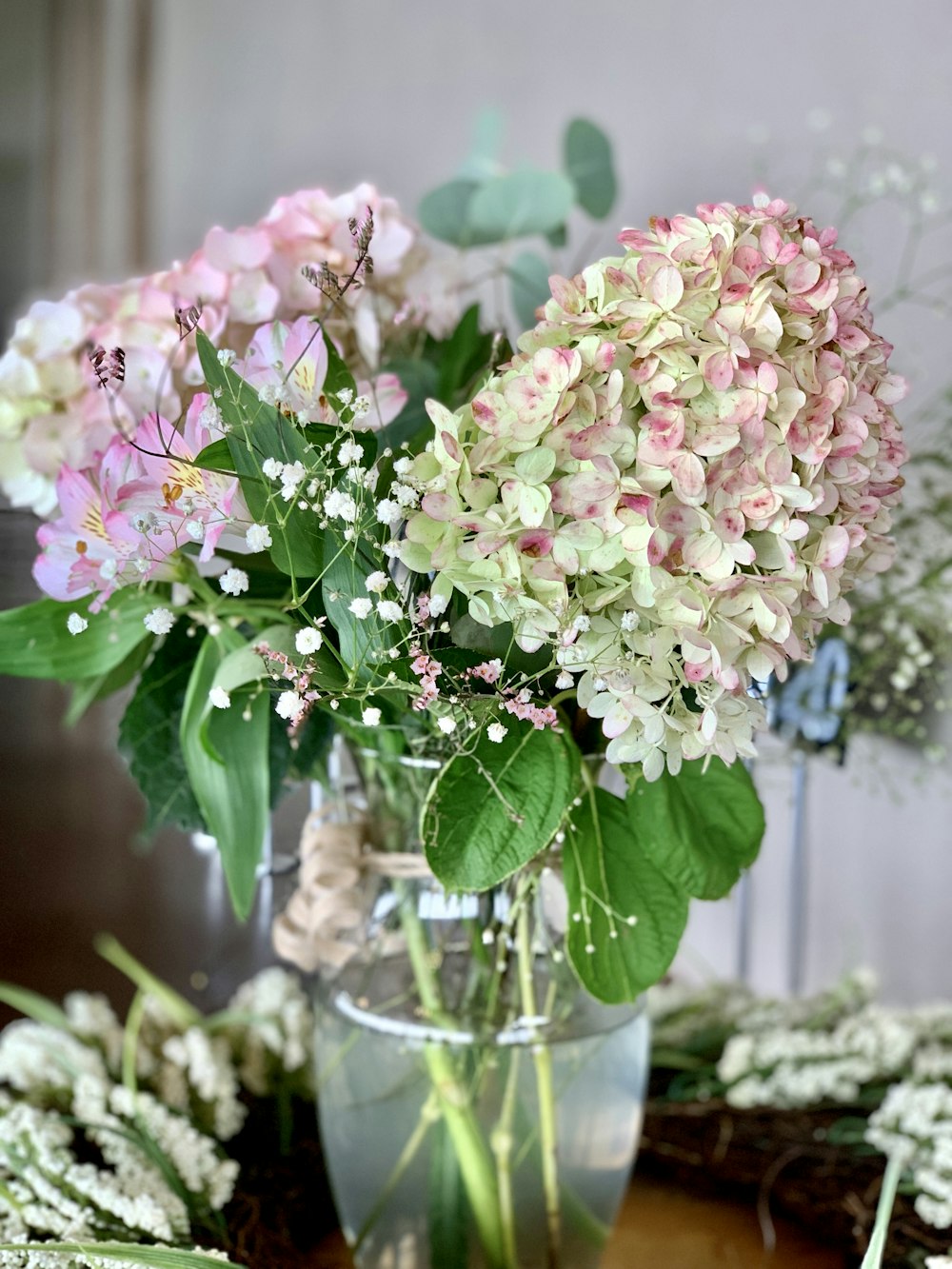 pink and white flowers in clear glass vase