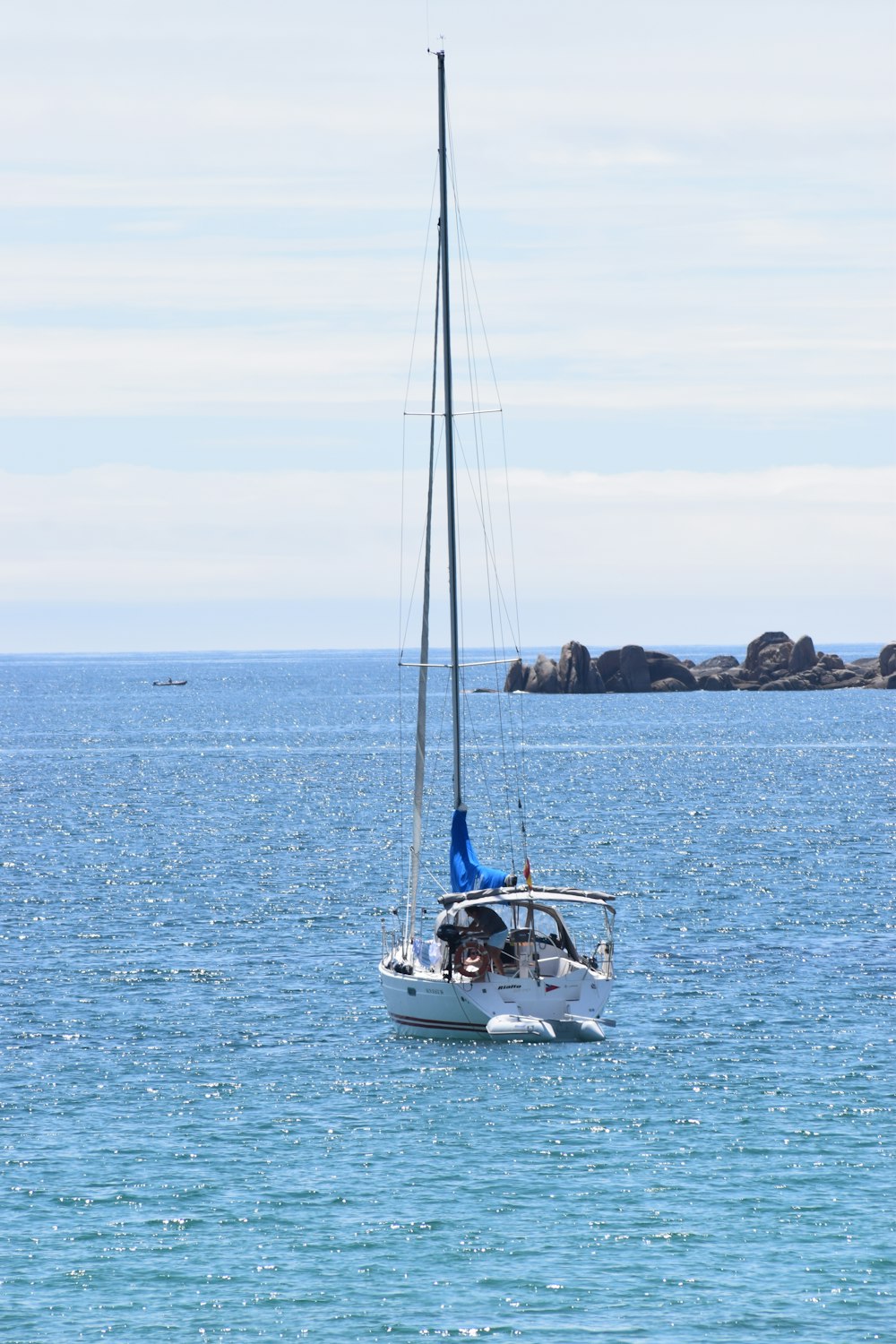 white and blue sailboat on sea during daytime