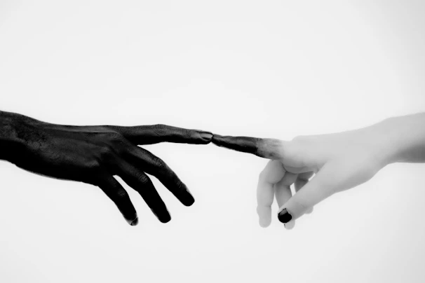 A delicate grayscale sketch of two hands reaching out, symbolizing connection.