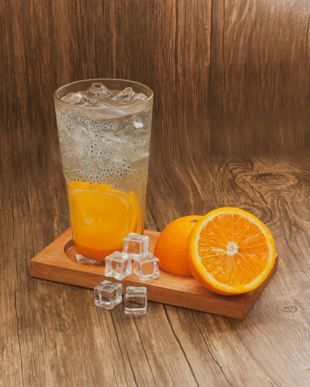 orange juice in clear drinking glass