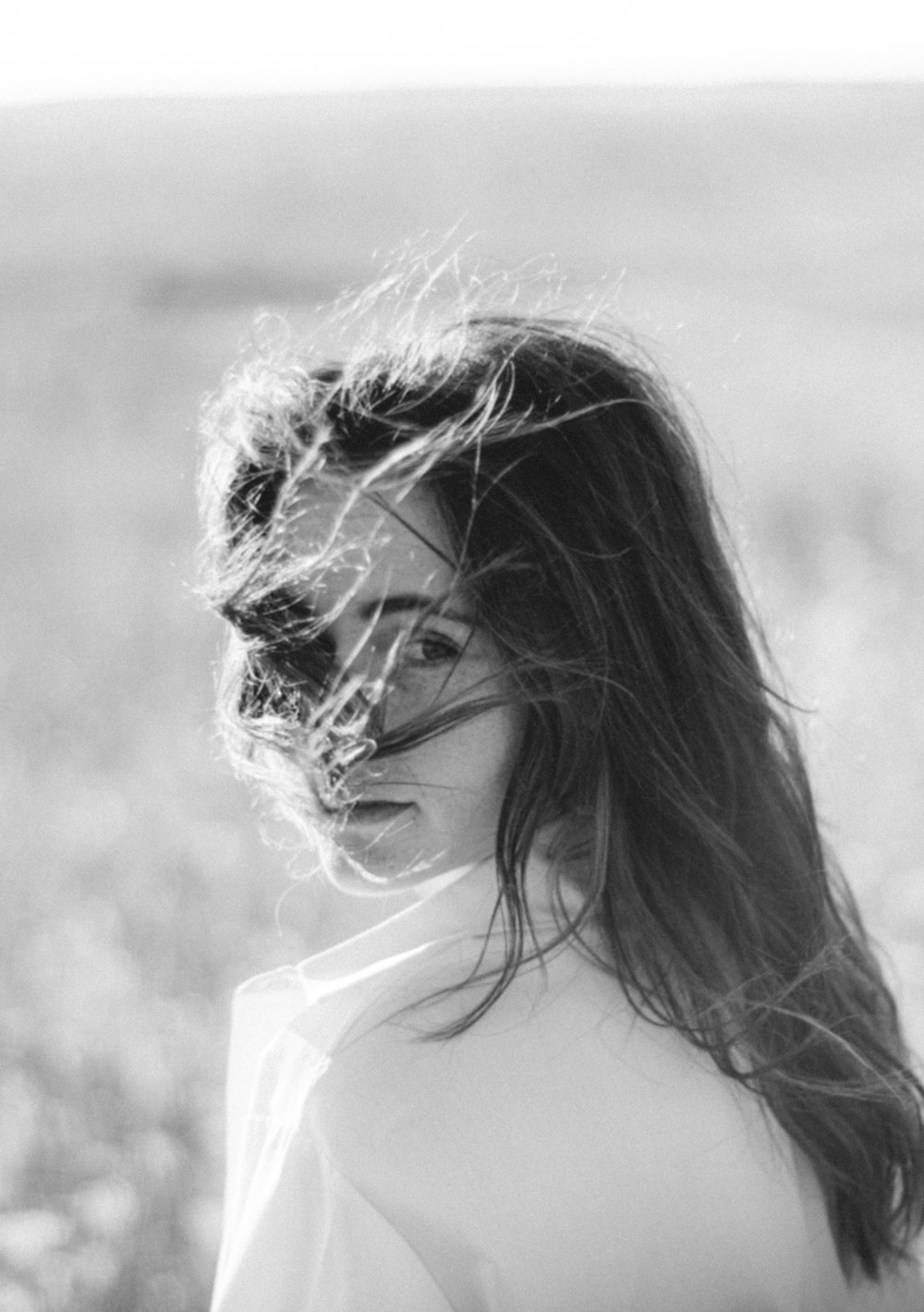 grayscale photo of woman in white tank top