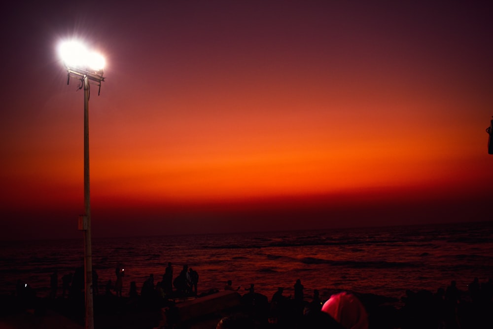 silhouette of people on beach during sunset