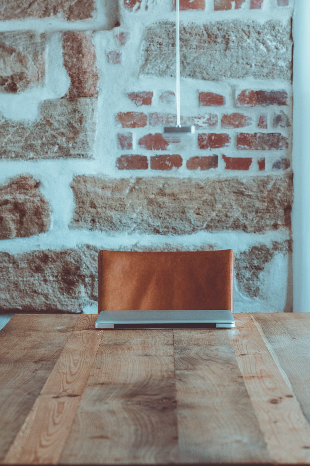 red laptop computer on brown wooden table