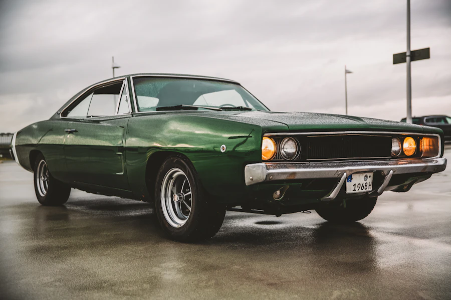 Green 1960s American saloon on a wet road with a period-correct plate