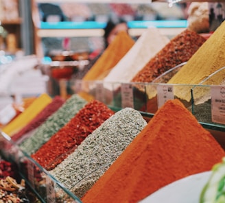 assorted color powder on brown wooden shelf