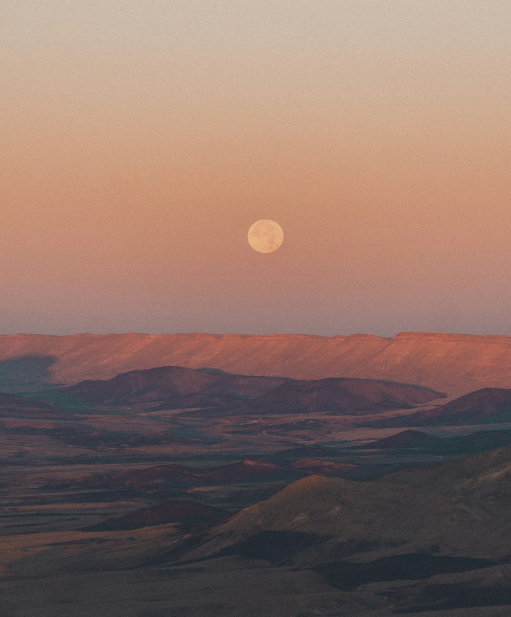 brown mountains under full moon