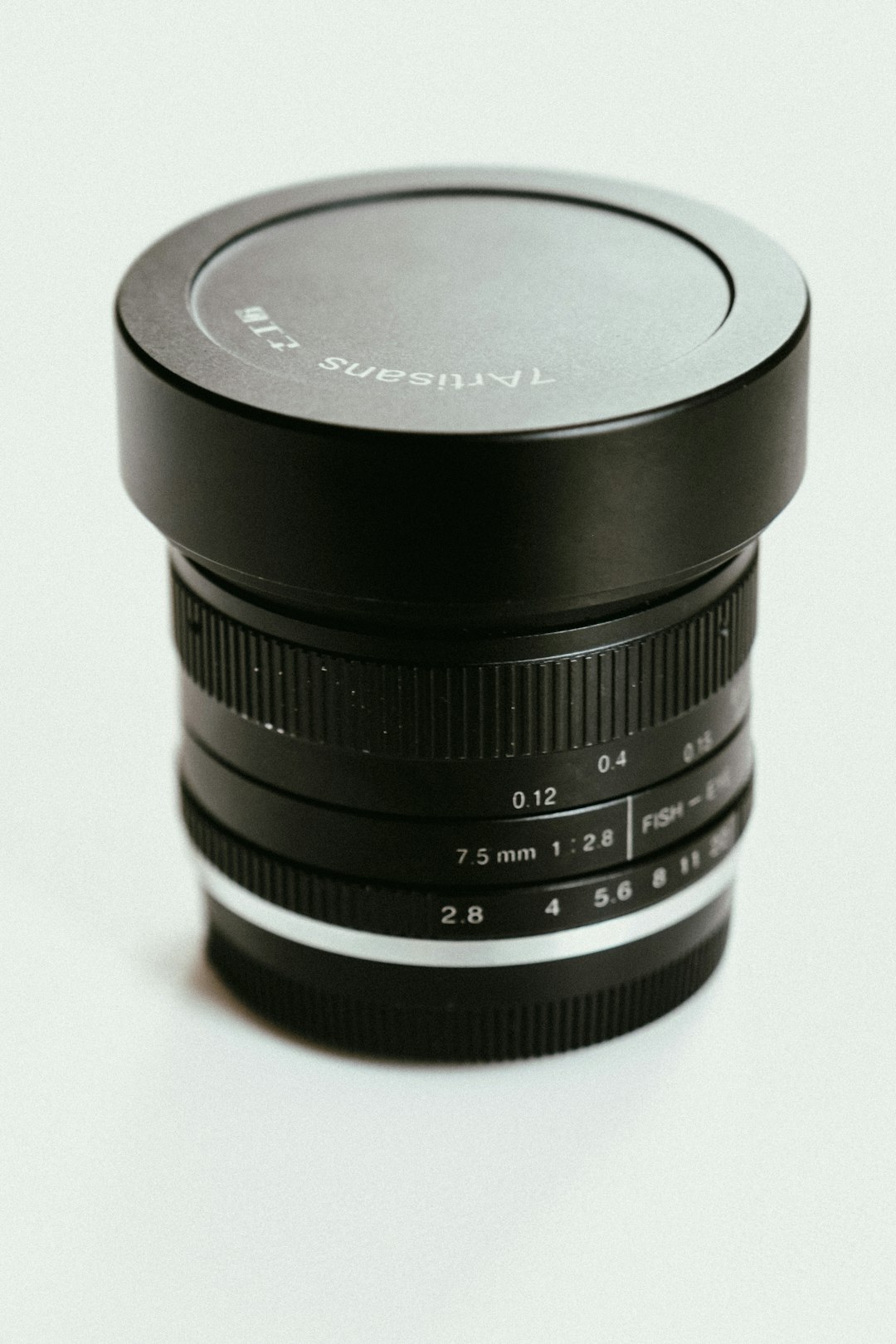 black canon camera lens on white surface