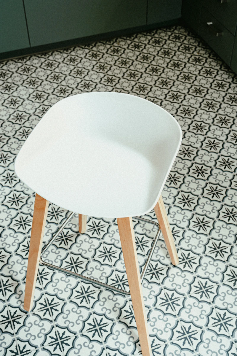 Grey and black vinyl tile floor with white chair