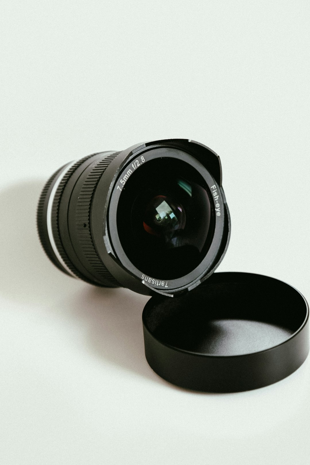 black camera lens on white surface