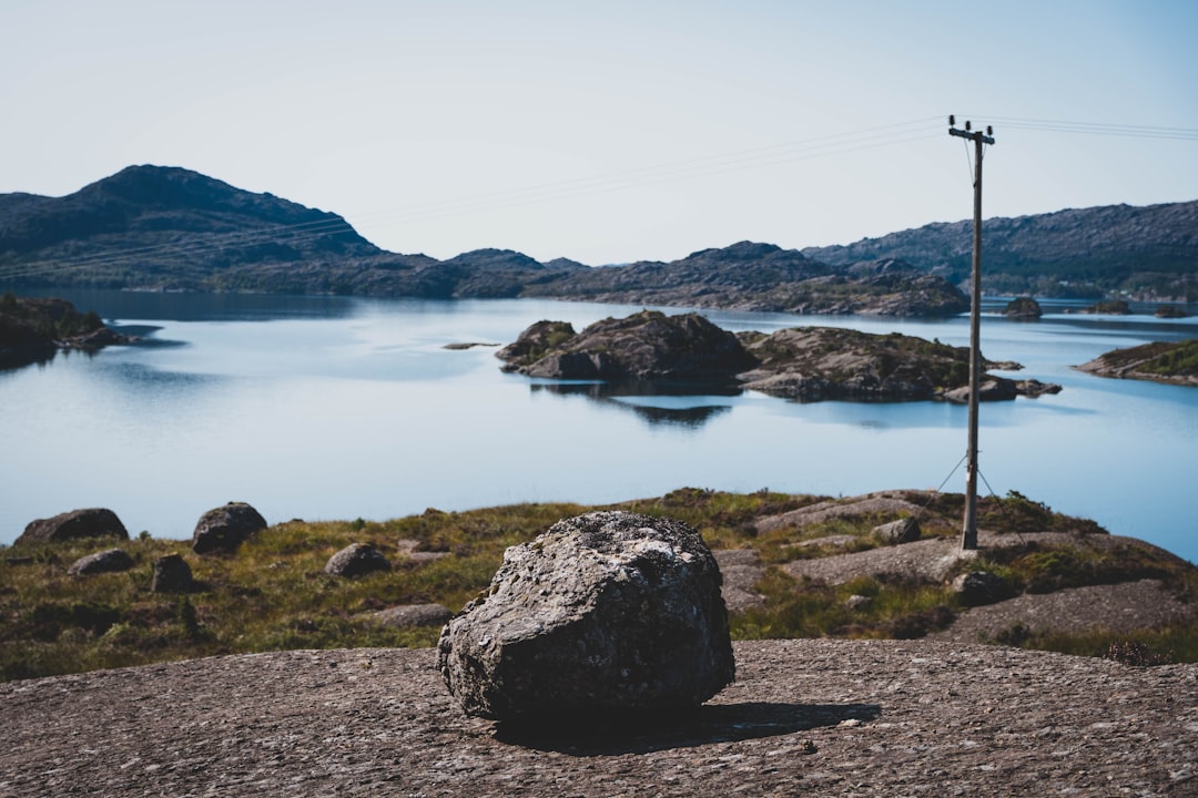 brown rock formation near body of water during daytime