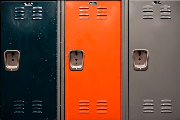 Metal locker with 150 mm legs in a bright locker room setting