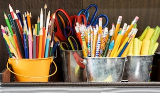 assorted color pencils in yellow bucket
