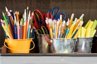 assorted color pencils in yellow bucket