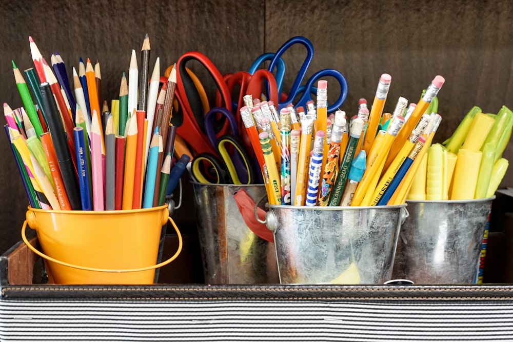 assorted color pencils in yellow bucket