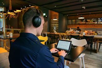 man in black suit jacket wearing black headphones