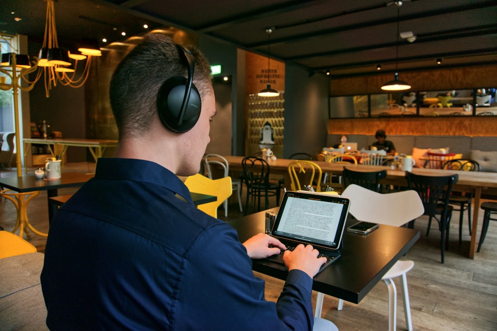 man in black suit jacket wearing black headphones