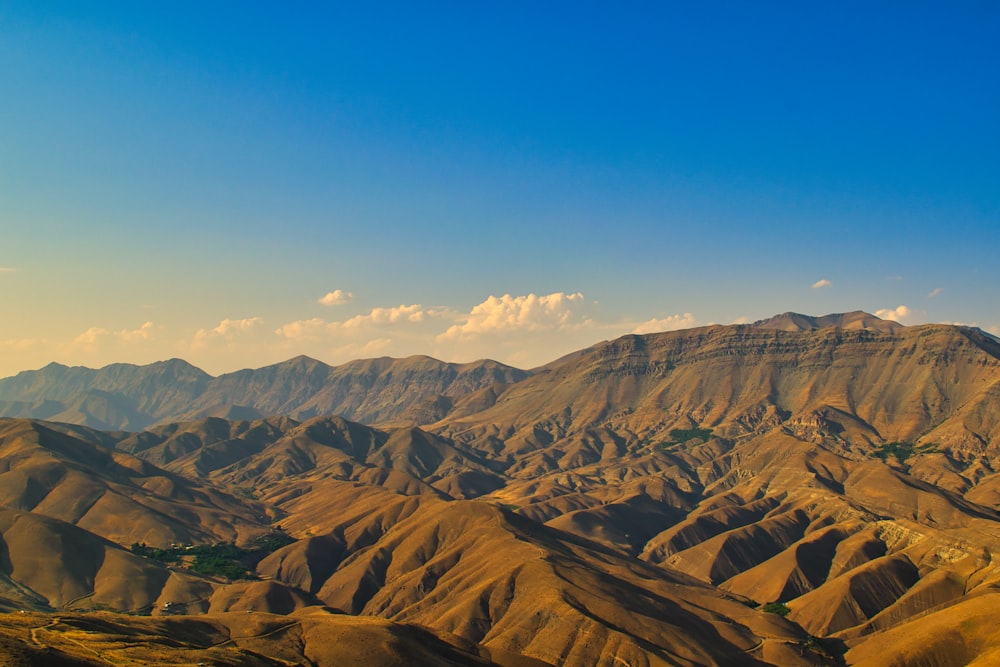 brown mountains under blue sky during daytime