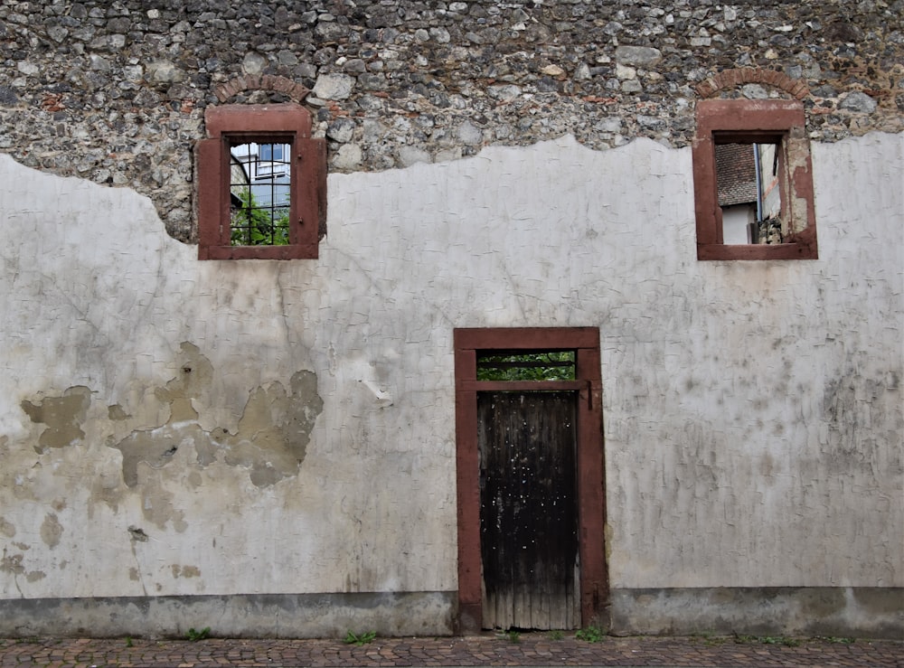 brown wooden window on white concrete wall