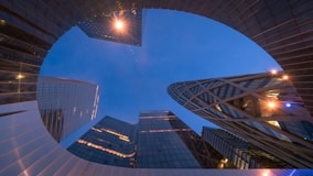 worms eye view of city buildings during night time