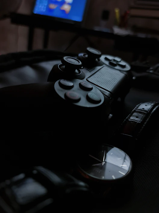 Close-up of a gamer holding a controller with a motorcycle parked in the background