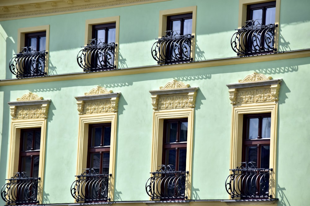 beige concrete building with black metal window grills