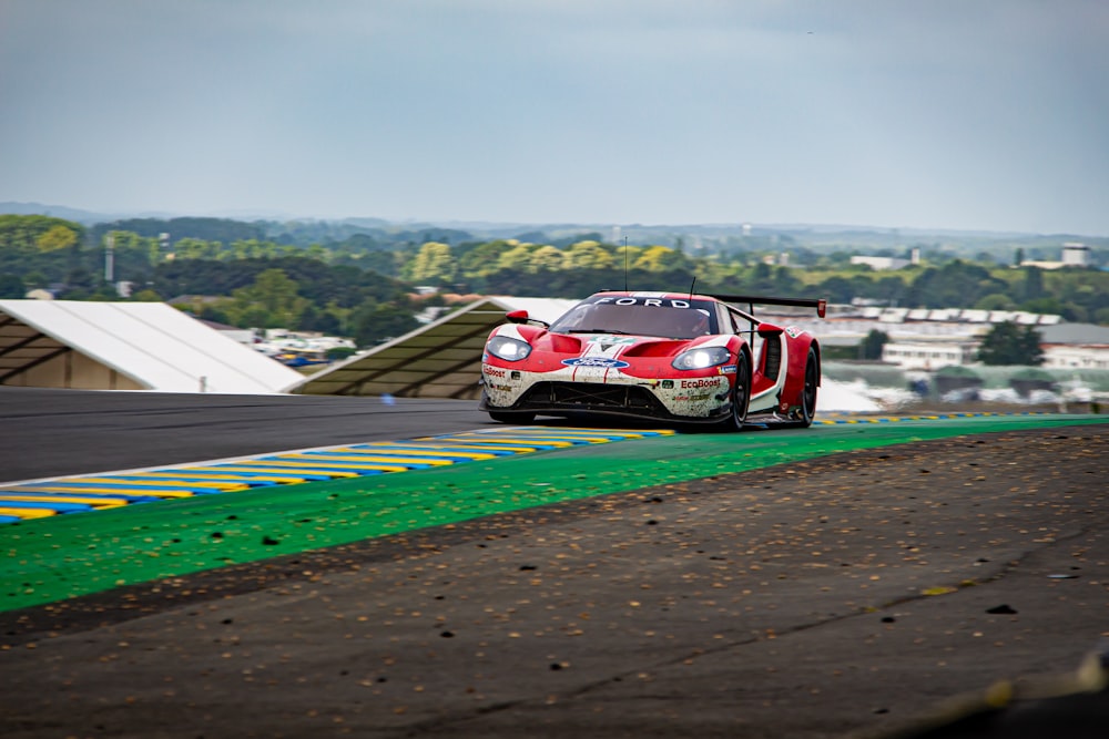 red and white porsche 911 on road during daytime