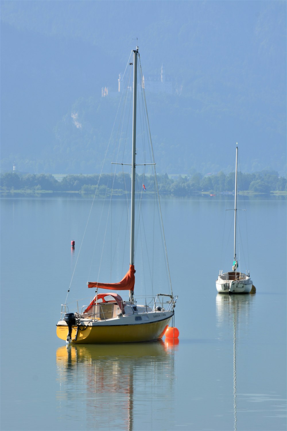 yellow and white boat on sea during daytime