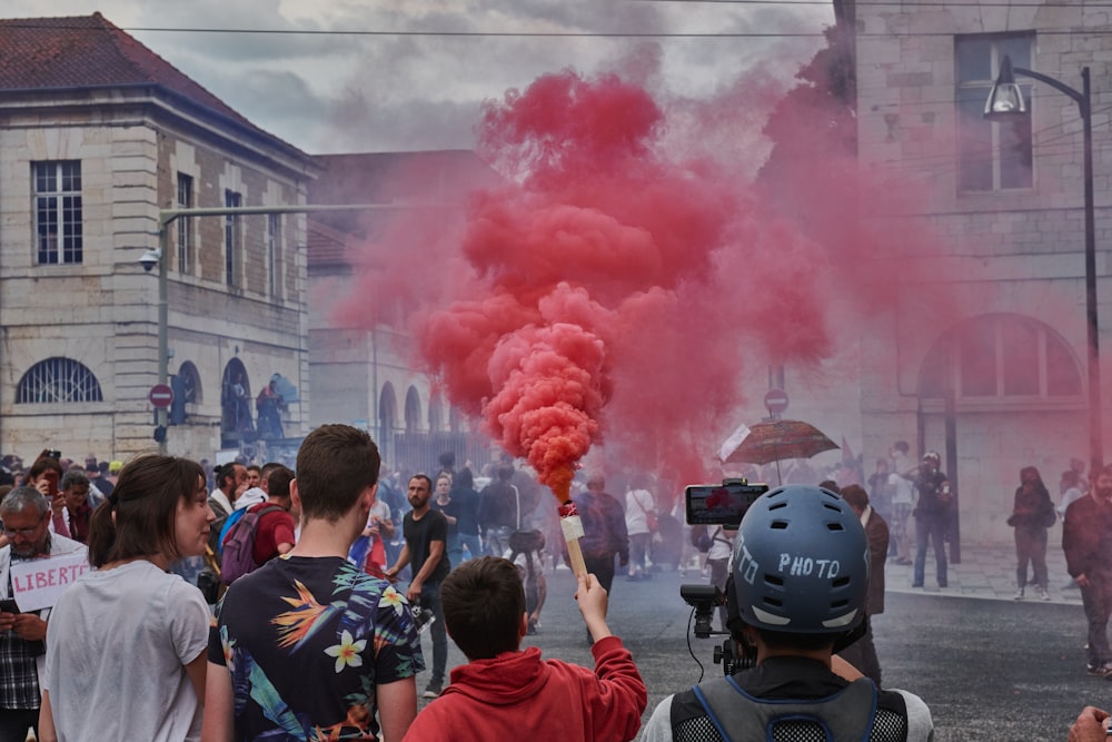 people in red shirt holding red powder