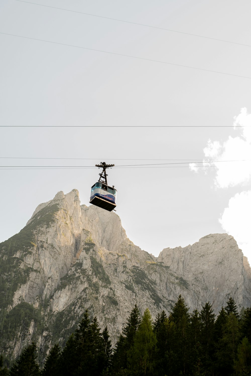 person in black jacket standing on top of mountain during daytime