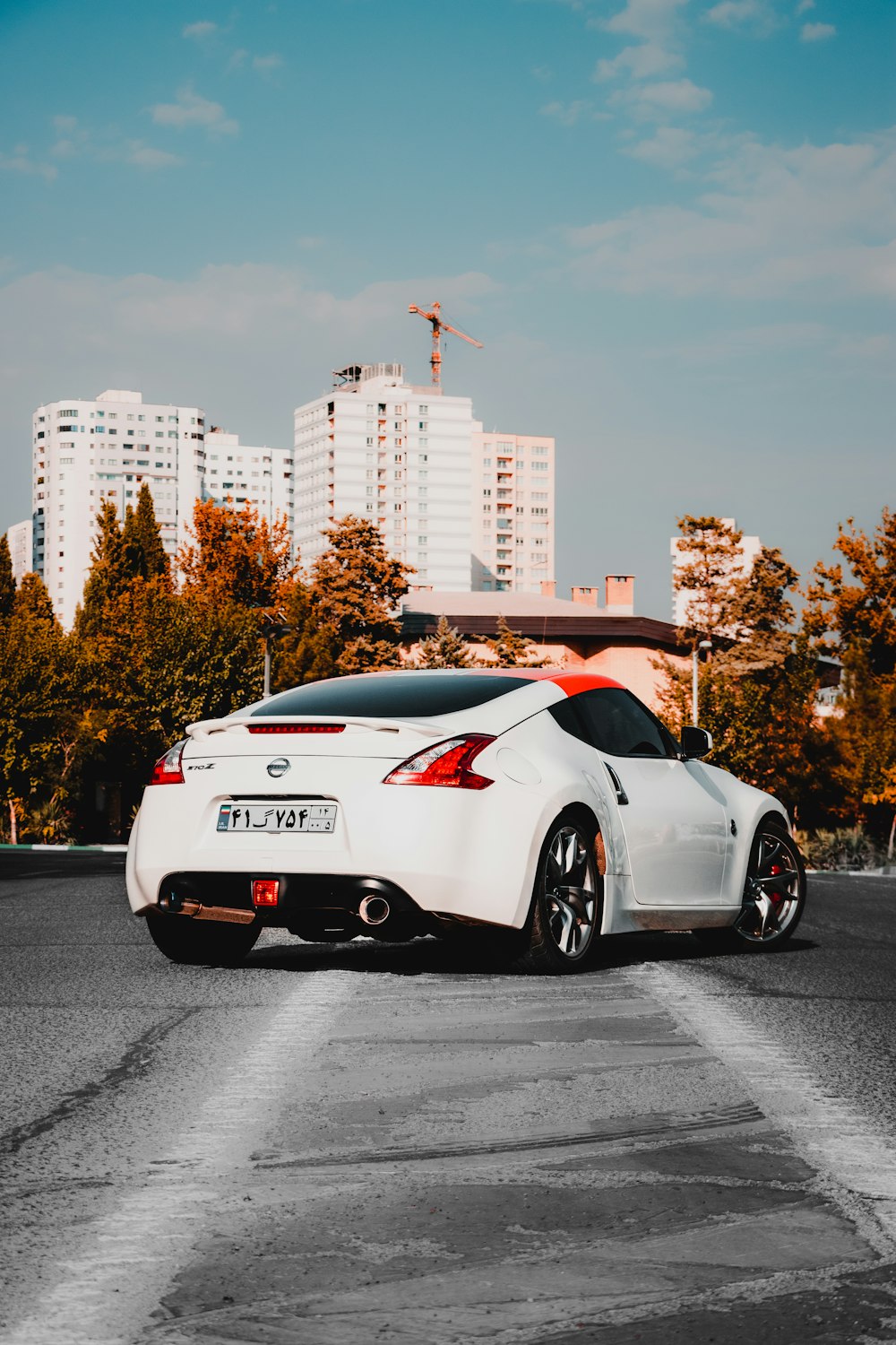 white and red porsche 911 parked on road during daytime