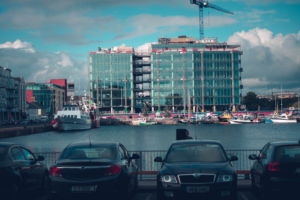 cars parked on parking lot near buildings during daytime