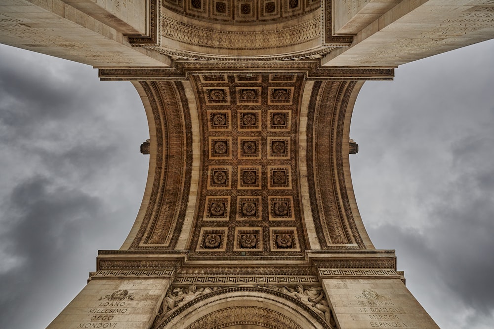 brown concrete building under white clouds during daytime