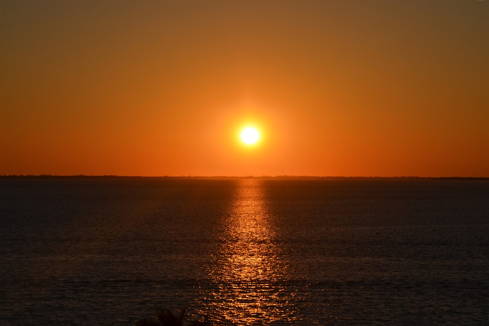 sunset over the sea with body of water