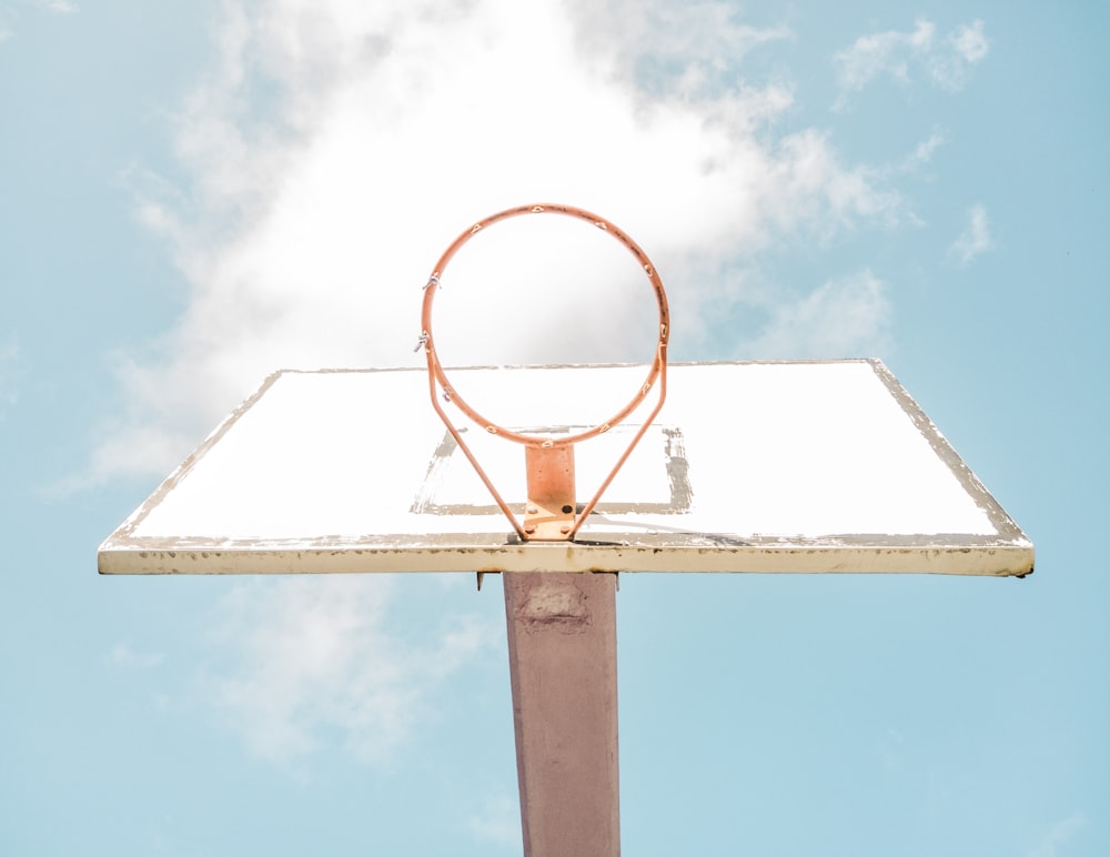 white and brown basketball hoop under blue sky during daytime
