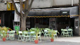Outdoor seating area of Nakba cafe with green plants and relaxed atmosphere