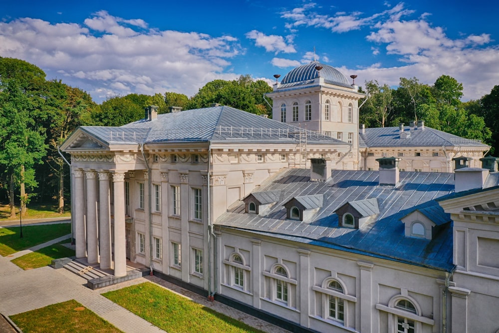 Weißes Betongebäude unter blauem Himmel tagsüber