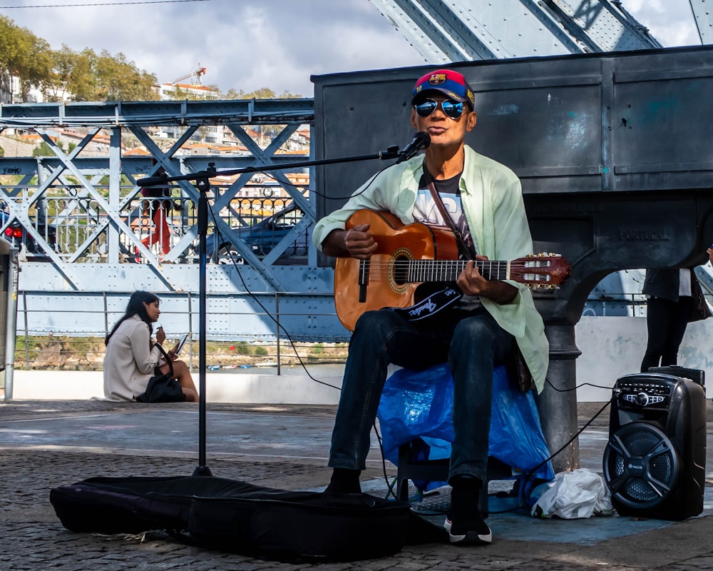 man in white shirt playing guitar