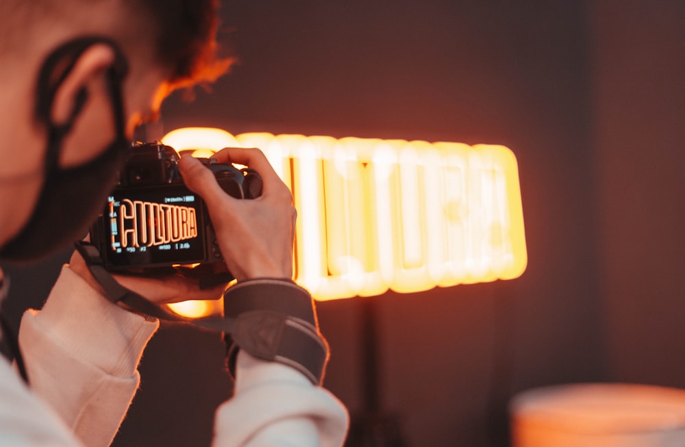 person holding black dslr camera