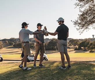 man in black t-shirt and brown shorts playing golf during daytime