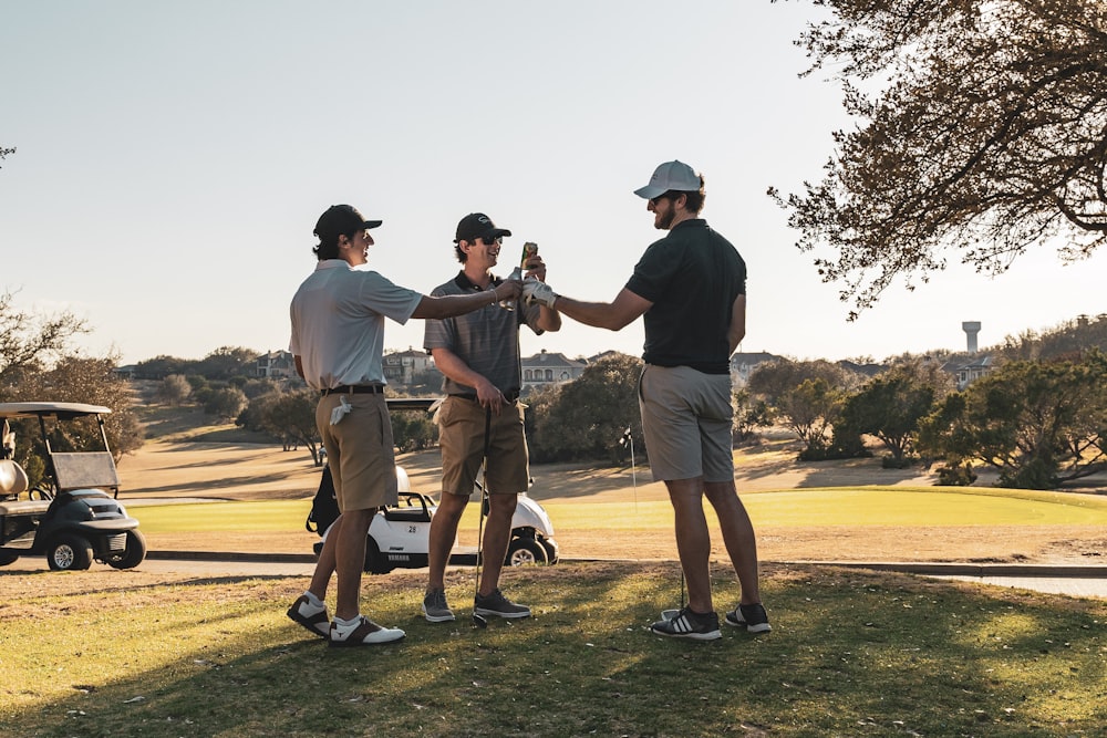 man in black t-shirt and brown shorts playing golf during daytime