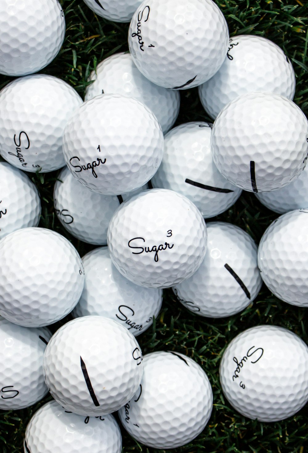 white golf ball lot on black background