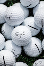 Golf accessories including gloves, tees, and ball markers neatly arranged on a white surface.