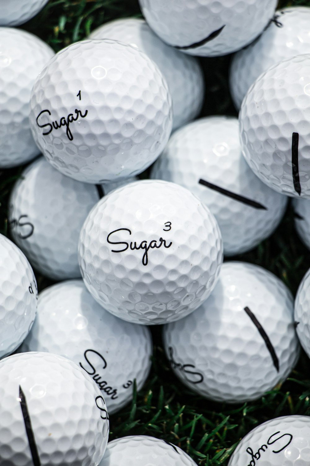 white golf ball lot on black background