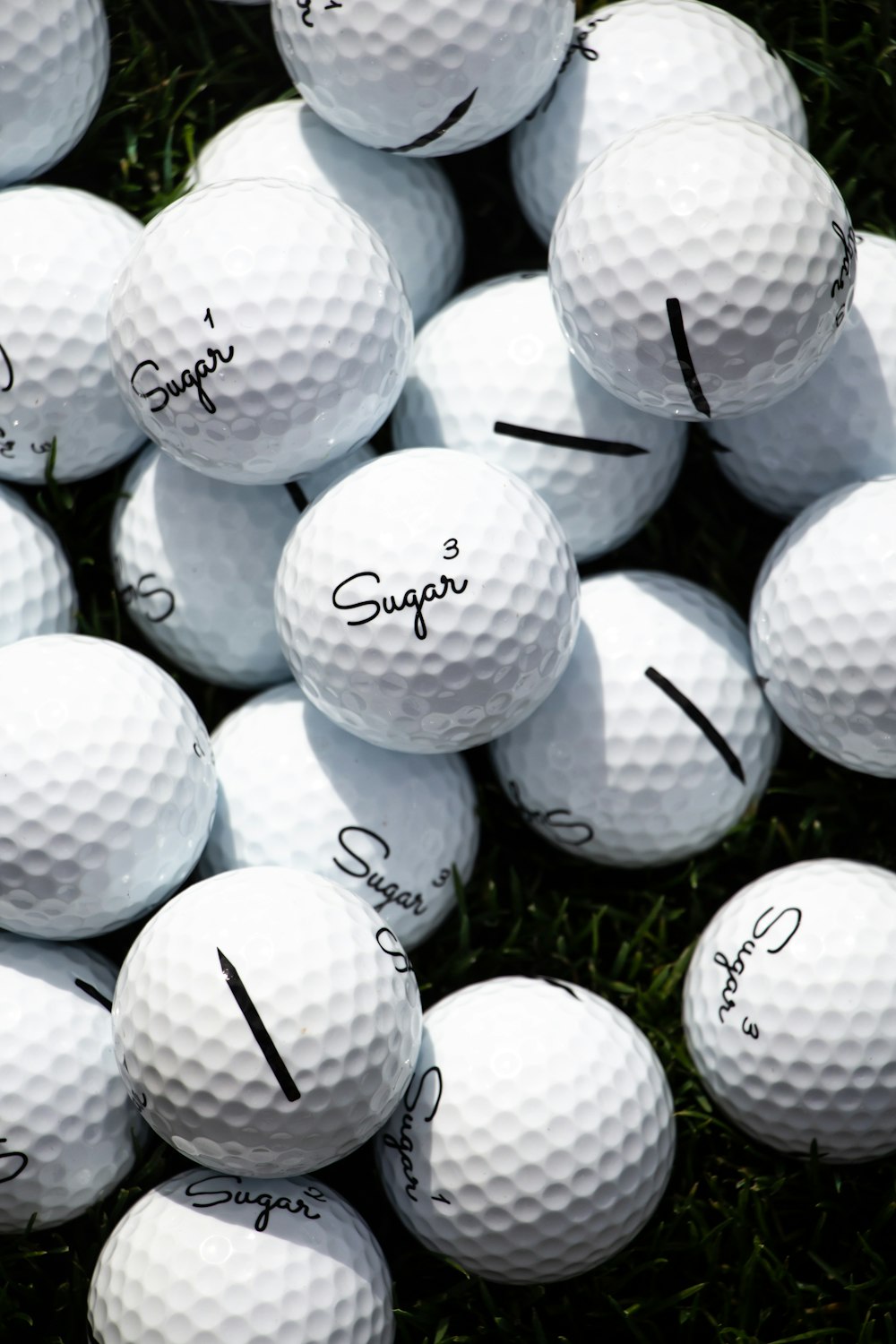 white golf ball lot on green grass field