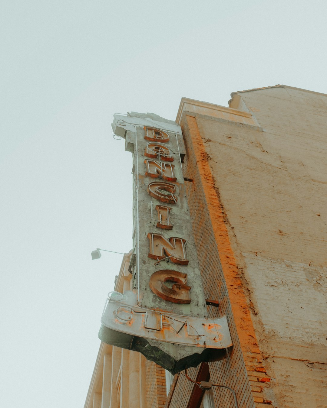 brown concrete building with brown wooden signage