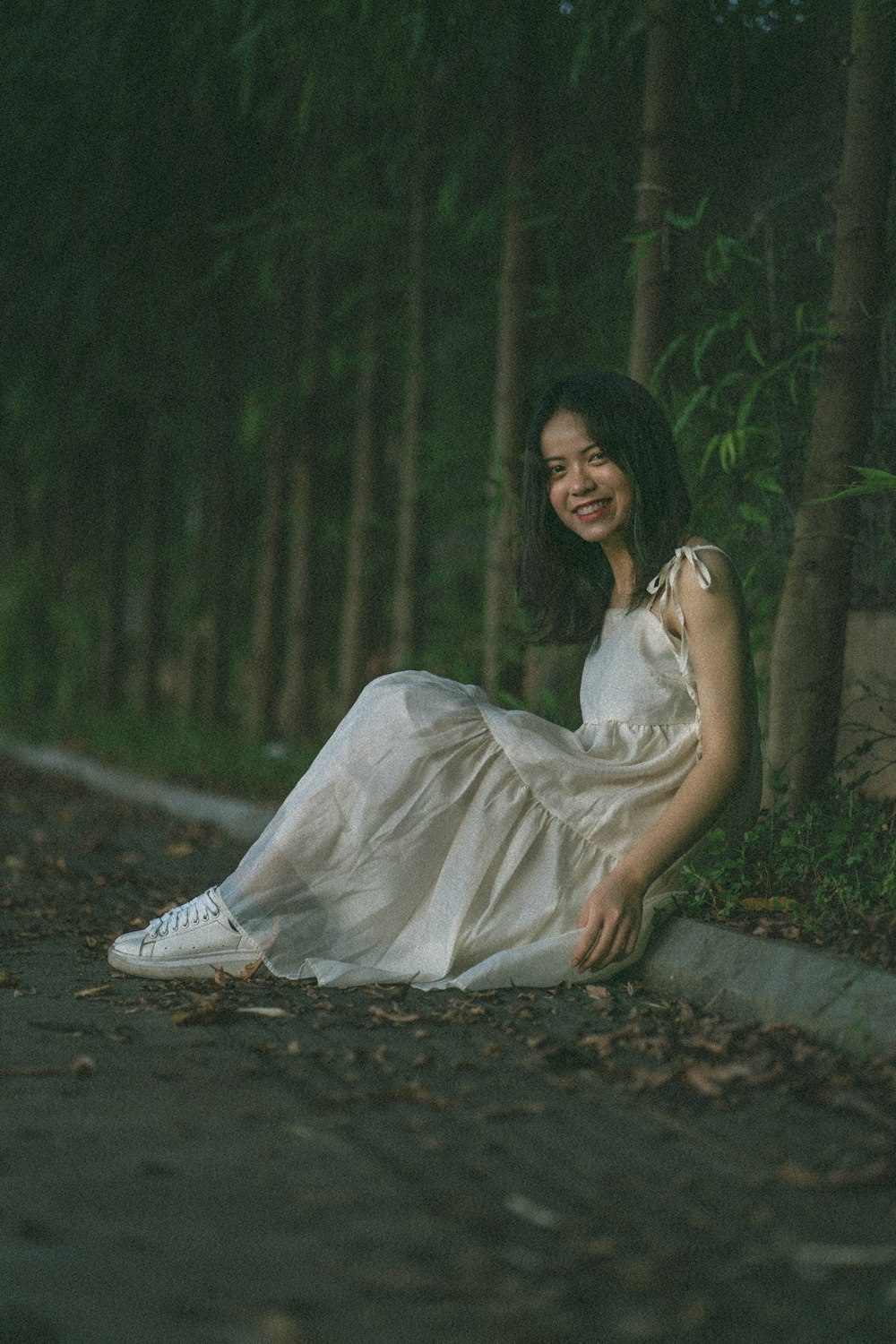 woman in white dress sitting on ground