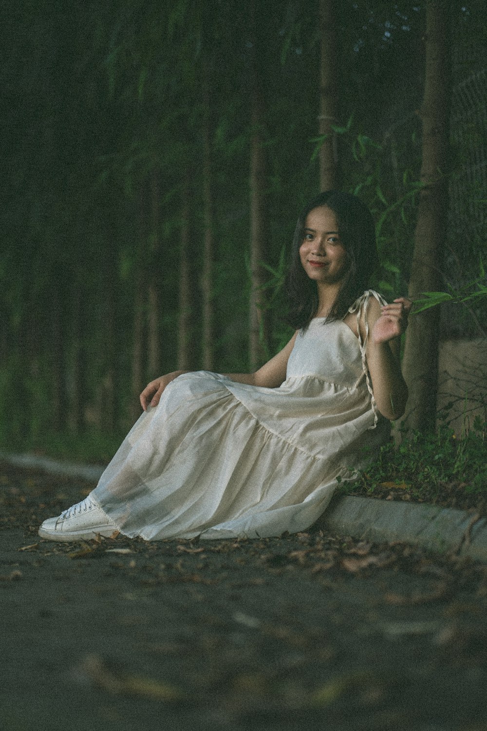 woman in white dress sitting on ground
