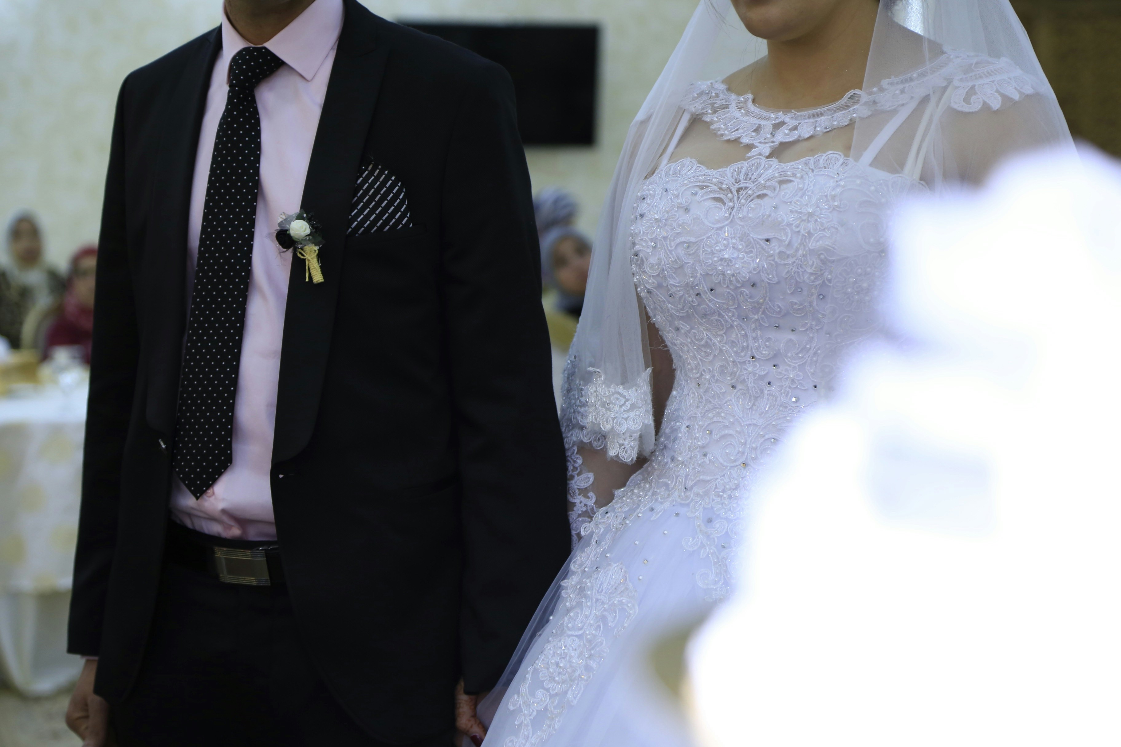 woman in white wedding dress and man in black suit